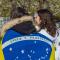 A photo of two people from the back wrapped in flags.